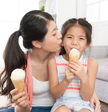 a mother and daughter eating ice cream